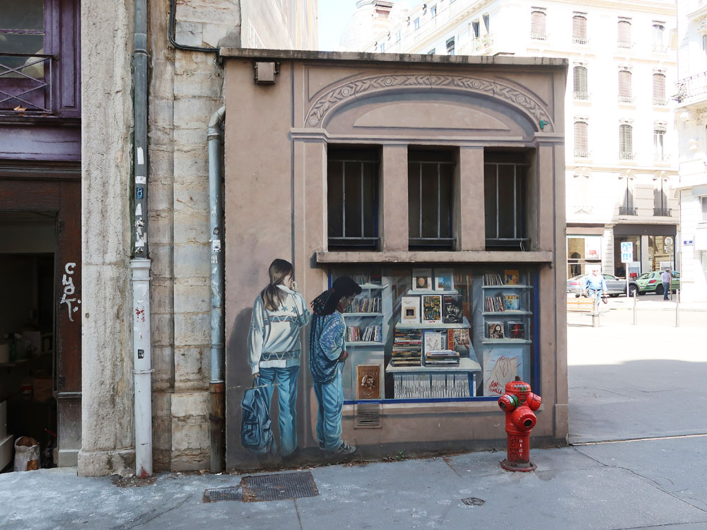 Trompe l'oeil painted on the corner of a building.