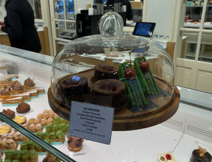 Cakes are displayed in glass cases.