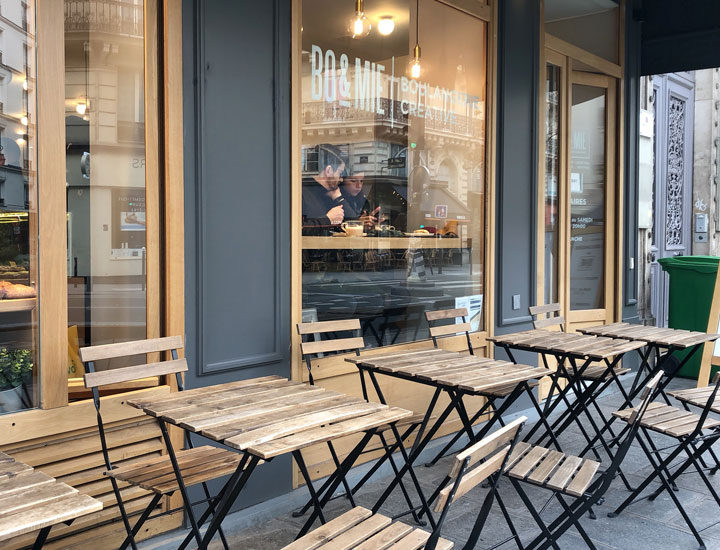 Chairs and tables placed outside the shop.