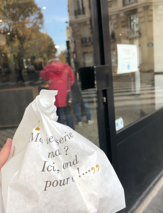 Paper bag containing croissants.