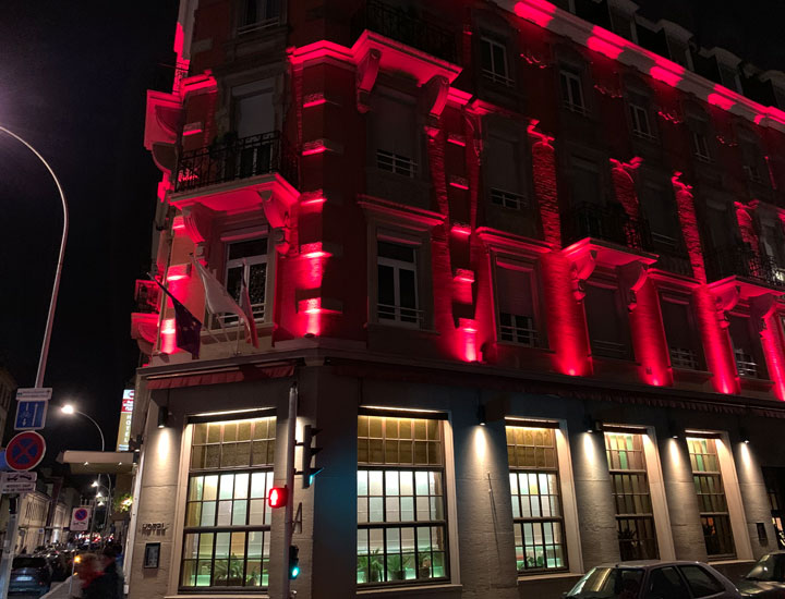 The exterior of the hotel lit up.